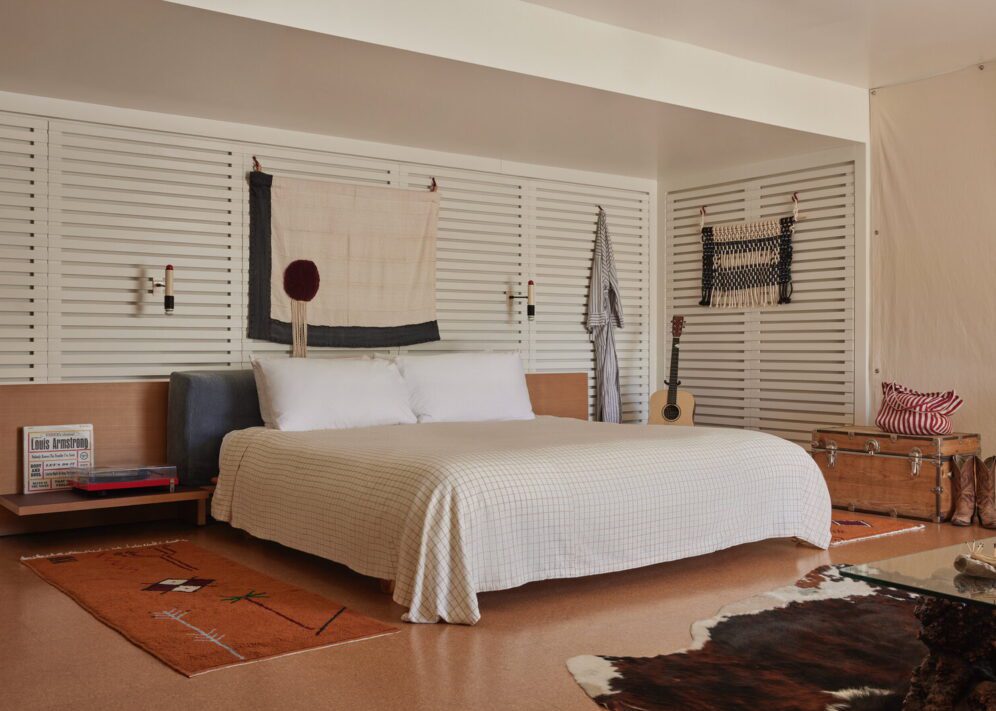 spacious king bed is adorned by wall-mounted night lights